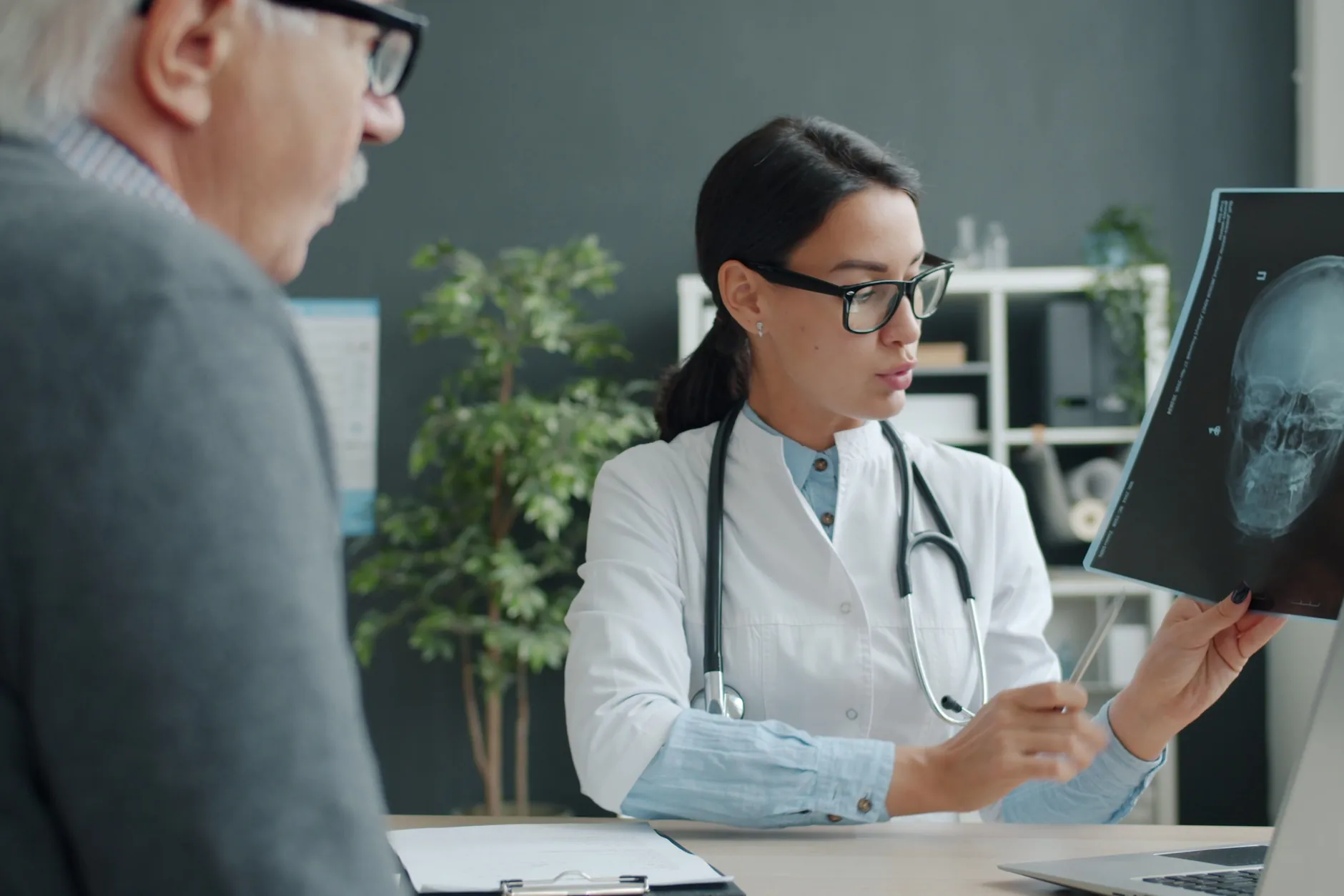 A doctor reviews a scan with an older patient during a new-patient visit